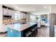 Open kitchen with a center island, modern countertops, and a clear view into the living room with a fireplace at 25338 E Costilla Pl, Aurora, CO 80016