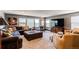 Cozy living room showcasing comfortable seating, a large screen TV, and plenty of natural light at 25338 E Costilla Pl, Aurora, CO 80016