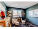 Cozy living room featuring modern decor, gray walls and a large window at 25338 E Costilla Pl, Aurora, CO 80016