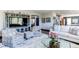 Open-concept living room featuring stylish decor, a modern entertainment center, and comfortable seating at 25338 E Costilla Pl, Aurora, CO 80016