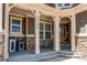 Charming covered porch with stone accents, offering a welcoming entrance to the home at 25338 E Costilla Pl, Aurora, CO 80016
