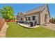 Well-maintained backyard with a concrete patio, artificial turf, privacy fence, and a BBQ grill for outdoor entertaining at 10639 Worchester Dr, Commerce City, CO 80022