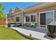Cozy backyard featuring a concrete patio with an outdoor seating area and BBQ grill at 10639 Worchester Dr, Commerce City, CO 80022