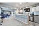 Finished basement bar with seating for four, modern appliances, and TV at 10639 Worchester Dr, Commerce City, CO 80022