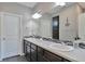 Elegant bathroom featuring a double vanity, contemporary lighting, and a separate shower, perfect for a refreshing start at 10639 Worchester Dr, Commerce City, CO 80022