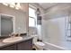 Well-lit bathroom with shower-tub combo, patterned shower curtain, and vanity sink at 10639 Worchester Dr, Commerce City, CO 80022