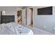 Cozy bedroom with dresser, access to hallway and bathroom, and mounted TV at 10639 Worchester Dr, Commerce City, CO 80022