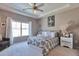 Bright bedroom with a queen-sized bed, tray ceiling, and stylish decor, offering a peaceful retreat at 10639 Worchester Dr, Commerce City, CO 80022