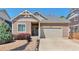 Charming single-Gathering home with a well-maintained front yard and two-car garage on a sunny day at 10639 Worchester Dr, Commerce City, CO 80022