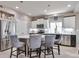 Modern kitchen featuring stainless steel appliances, a center island with seating, and bright lighting at 10639 Worchester Dr, Commerce City, CO 80022