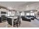 Open-concept living area with a modern kitchen, dining space, and comfortable seating, perfect for entertaining at 10639 Worchester Dr, Commerce City, CO 80022