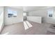 Large bonus room with carpeting and large windows at 2161 Flower Blossom Ave, Brighton, CO 80601