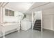 Basement area featuring utility sink, washer, dryer, and stairs to main level at 618 Milwaukee St, Denver, CO 80206