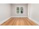 Bright bedroom featuring hardwood floors and a window with decorative trim at 618 Milwaukee St, Denver, CO 80206