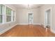 Bright dining room boasts hardwood floors, natural light from windows, and adjacent doorway to kitchen at 618 Milwaukee St, Denver, CO 80206