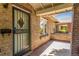 Cozy front porch with metal security door, brick facade and shady spot to sit at 618 Milwaukee St, Denver, CO 80206