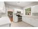 Modern kitchen features stainless steel appliances, white cabinetry and plenty of natural light at 618 Milwaukee St, Denver, CO 80206