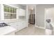 Bright kitchen features stainless steel refrigerator, tile flooring, and white cabinets at 618 Milwaukee St, Denver, CO 80206