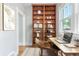 Bright office space featuring custom built-ins, a desk, and a large window at 618 Milwaukee St, Denver, CO 80206