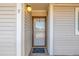 Condo building entrance with glass front door and a simple doormat at 2725 W 86Th Ave # 5, Westminster, CO 80031