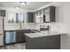 Modern kitchen with dark cabinetry, stainless steel appliances, and quartz countertops at 2725 W 86Th Ave # 5, Westminster, CO 80031