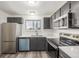 Modern kitchen with dark cabinetry, stainless steel appliances, and quartz countertops at 2725 W 86Th Ave # 5, Westminster, CO 80031