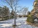 Snowy backyard with landscaping and a deck at 11701 Bent Oaks St, Parker, CO 80138