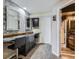 Basement vanity area with dual sinks and a large mirror at 11701 Bent Oaks St, Parker, CO 80138