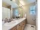 Bathroom with double vanity, large mirror, and tiled floor at 11701 Bent Oaks St, Parker, CO 80138