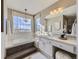 Elegant bathroom with a large soaking tub, double vanity, and window views at 11701 Bent Oaks St, Parker, CO 80138