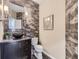 Modern bathroom with dark vanity, vessel sink, and stylish tile at 11701 Bent Oaks St, Parker, CO 80138