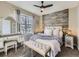 Main bedroom with rustic wood accent wall and plush bedding at 11701 Bent Oaks St, Parker, CO 80138