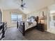 Large bedroom with carpeted floors, a king-size bed, and ample natural light at 11701 Bent Oaks St, Parker, CO 80138