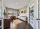 Home office with built-in shelving, hardwood floors, and a large window at 11701 Bent Oaks St, Parker, CO 80138