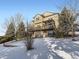 Two-story house exterior with a deck and snowy landscape at 11701 Bent Oaks St, Parker, CO 80138