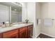 Clean bathroom with wood vanity, single sink, and shower at 1536 Sepia Ave, Longmont, CO 80501