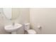 Clean bathroom with toilet, sink, and oval mirror at 1536 Sepia Ave, Longmont, CO 80501