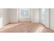 Bright bedroom with neutral carpeting and large window at 1536 Sepia Ave, Longmont, CO 80501