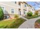 Tan two-story townhome exterior with landscaping and walkway at 1536 Sepia Ave, Longmont, CO 80501