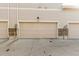 Attached garage with tan door at 1536 Sepia Ave, Longmont, CO 80501