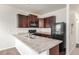 Modern kitchen with dark cabinets and granite counters at 1536 Sepia Ave, Longmont, CO 80501