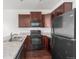 Modern kitchen with dark wood cabinets and appliances at 1536 Sepia Ave, Longmont, CO 80501