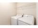 Laundry room with washer, dryer, and shelving at 1536 Sepia Ave, Longmont, CO 80501