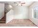 Empty living room with carpet, stairs, and window at 1536 Sepia Ave, Longmont, CO 80501