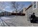 Spacious backyard featuring a concrete patio, storage shed, tall trees, and a wooden fence at 12218 S Oak Bluff Trl, Parker, CO 80134