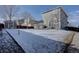 Snowy backyard with a gray house and a privacy fence enhancing the outdoor space at 12218 S Oak Bluff Trl, Parker, CO 80134