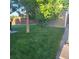 A verdant backyard featuring a grassy area, patio, a storage shed and mature shade trees at 12218 S Oak Bluff Trl, Parker, CO 80134