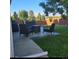 Backyard featuring an outdoor seating area, lush lawn, and a wooden fence at 12218 S Oak Bluff Trl, Parker, CO 80134