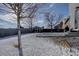 Backyard featuring a shed and a snow-covered yard, enclosed by a stone and wood fence at 12218 S Oak Bluff Trl, Parker, CO 80134