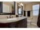 Bathroom featuring double sink vanity with granite countertop and dark wood cabinets at 12218 S Oak Bluff Trl, Parker, CO 80134